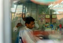 A man getting a haircut in a local salon