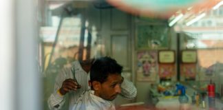 A man getting a haircut in a local salon