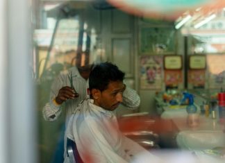 A man getting a haircut in a local salon