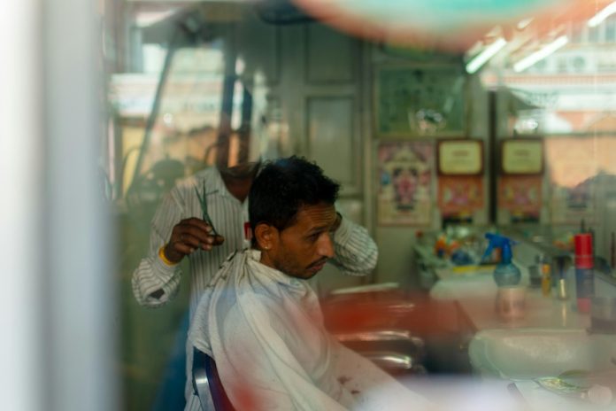 A man getting a haircut in a local salon