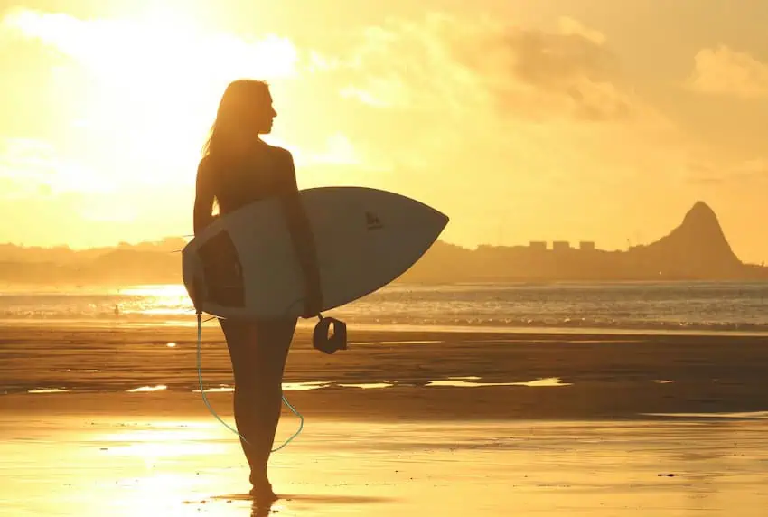 A woman ready to take on the crests with her surfboard