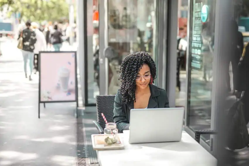 A woman working remotely at a local coffee shop