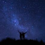 A couple watches the Milky Way in the wild