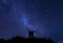 A couple watches the Milky Way in the wild