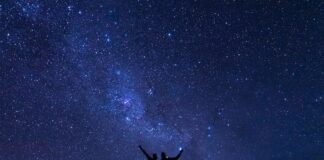 A couple watches the Milky Way in the wild