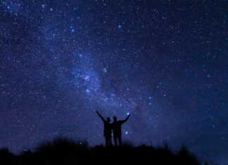 A couple watches the Milky Way in the wild