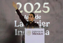 President Sheinbaum stands in front of a banner reading "2025"