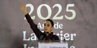 President Sheinbaum stands in front of a banner reading "2025"