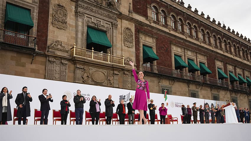 President Claudia Sheinbaum waves to the crowd from the stage after giving her 100-day address in Mexico City