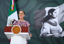 President Claudia Sheinbaum at the podium during her morning mañanera, or press conference, in Acapulco, where she discussed the case of the Ayotzinapa 43.