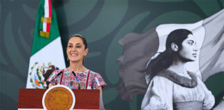 President Claudia Sheinbaum at the podium during her morning mañanera, or press conference, in Acapulco, where she discussed the case of the Ayotzinapa 43.