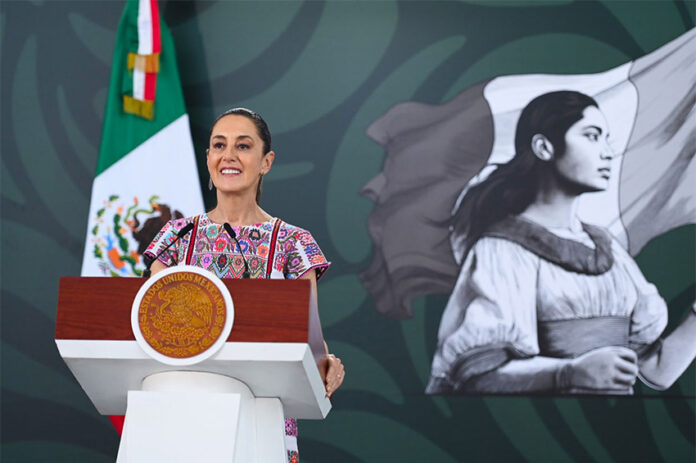 President Claudia Sheinbaum at the podium during her morning mañanera, or press conference, in Acapulco, where she discussed the case of the Ayotzinapa 43.