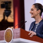 President Claudia Sheinbaum smiles in a side profile photo taken during her mañanera press conference
