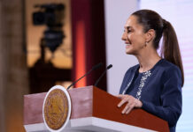 President Claudia Sheinbaum smiles in a side profile photo taken during her mañanera press conference