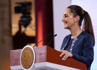 President Claudia Sheinbaum smiles in a side profile photo taken during her mañanera press conference