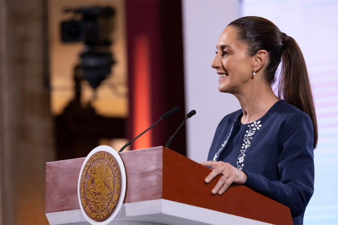 President Claudia Sheinbaum smiles in a side profile photo taken during her mañanera press conference