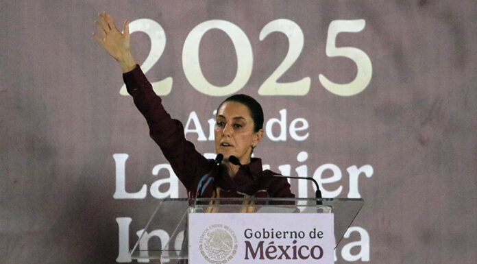 President Sheinbaum stands in front of a banner reading "2025"