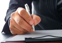 A businessman signing a letter