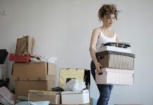 A woman organizing her stuff in a messy room