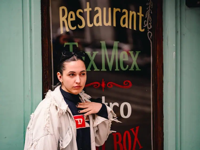 A woman posing outside a TexMex restaurant