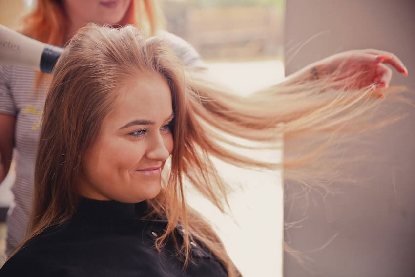 A woman having her hair cut