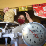 A woman weighs tortillas for sale, representing inflation in Mexico