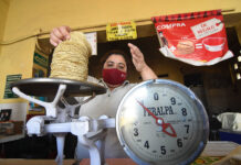 A woman weighs tortillas for sale, representing inflation in Mexico