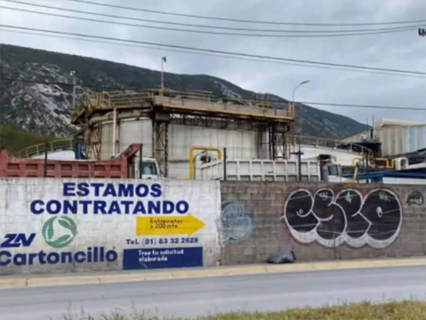 The Zinc Nacional hazardous waste processing plant in Monterrey with industrial structure behind a brick wall