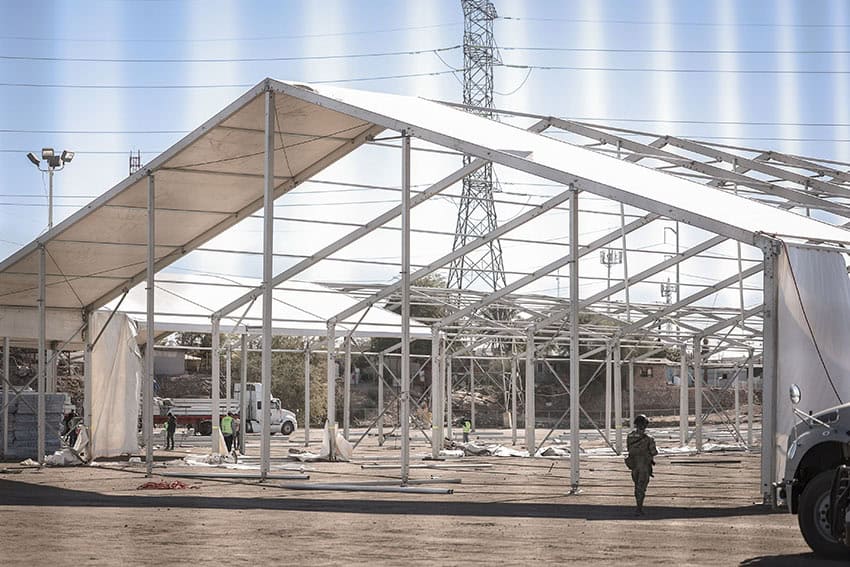 A Mexican soldier guards an under-construction migrant refuge in Mexicali, part of the destination for new funds after the INM budget increase