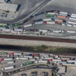 An aerial view of semitrailers waiting in long lines for customs at a US-Mexico border crossing, which are facing delays this week