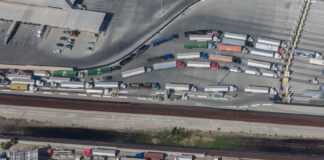 An aerial view of semitrailers waiting in long lines for customs at a US-Mexico border crossing, which are facing delays this week