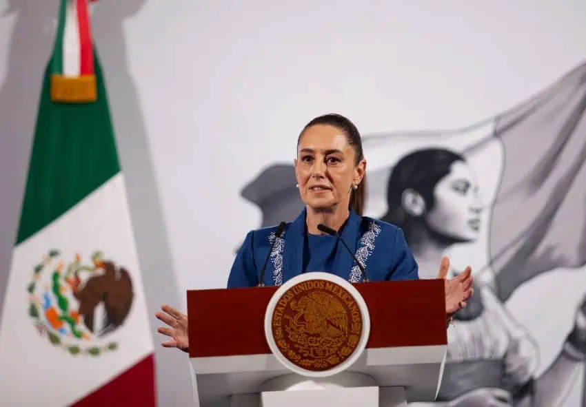 President Claudia Sheinbaum behind the presidential podium at the National Palace speaking about US-Mexico relations