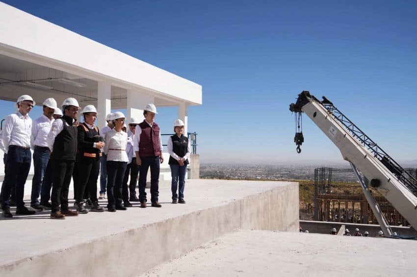 President Sheinbaum of Mexico standing atop an unfinished building at a construction site for the Guadalupe Victoria water treatment plant in Durango, Mexico.