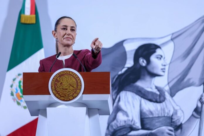 President Claudia Sheinbaum, whose approval rating is higher than ever, points to the audience during her morning press conference