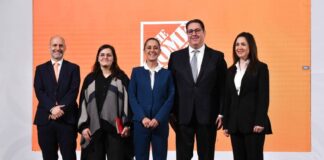 President Sheinbaum and the Home Depot Mexico CEO stand on a stage to announce the company's investment in Mexico