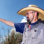 A man points at the Casa Blanca wetlands