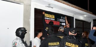 México state authorities close a barbershop in an anti-crime raid