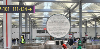 Passengers walk through AIFA airport