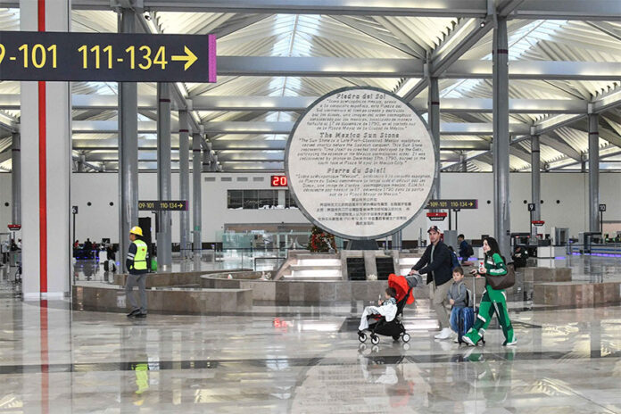 Passengers walk through AIFA airport