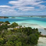 A view of the clear blue water of Bacalar Lagoon, with mangroves on the shore.