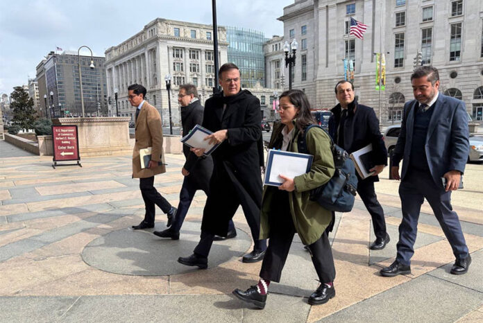 Marcelo Ebrard and other officials walk thorugh downtown Washington, D.C.