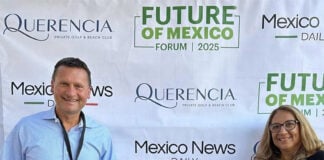 Travis and Tamanna Bembenek stand smiling in front of a banner reading Mexico News Daily, Querencia and Future of Mexico