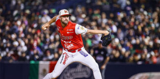 A baseball pitcher in a red Mexican uniform throws the ball at a Caribbean Series Mexico vs Dominican Republic game