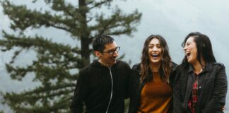 Three people laughing together
