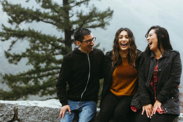 Three people laughing together