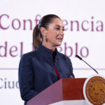 President Sheinbaum at the podium of her Monday mañanera conference, where she discussed Ebrard's plans to attend tariff talks in the U.S.