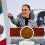 President Claudia Sheinbaum points to her audience during her Friday morning press conference, where she hinted at the role of judicial corruption in Thursday's mass extradition.