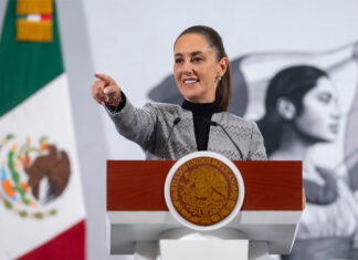 President Claudia Sheinbaum points to her audience during her Friday morning press conference, where she hinted at the role of judicial corruption in Thursday's mass extradition.