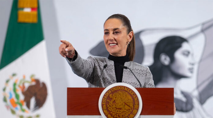 President Claudia Sheinbaum points to her audience during her Friday morning press conference, where she hinted at the role of judicial corruption in Thursday's mass extradition.