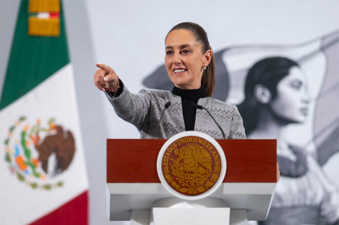 President Claudia Sheinbaum points to her audience during her Friday morning press conference, where she hinted at the role of judicial corruption in Thursday's mass extradition.